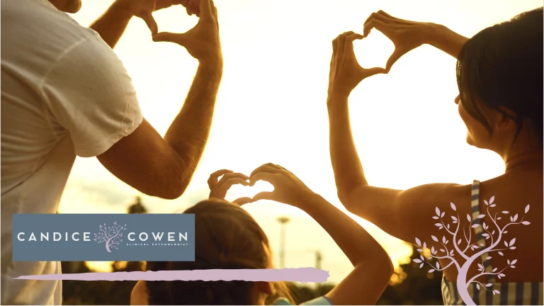 A family making heart shapes with their hands