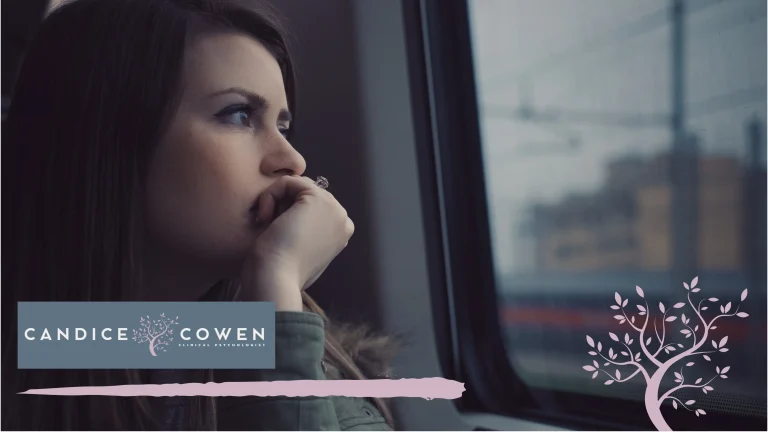 A woman looking thoughtfully through a window
