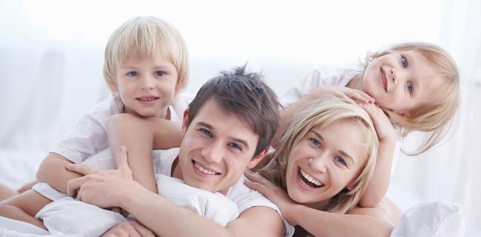 A smiling family with two children.