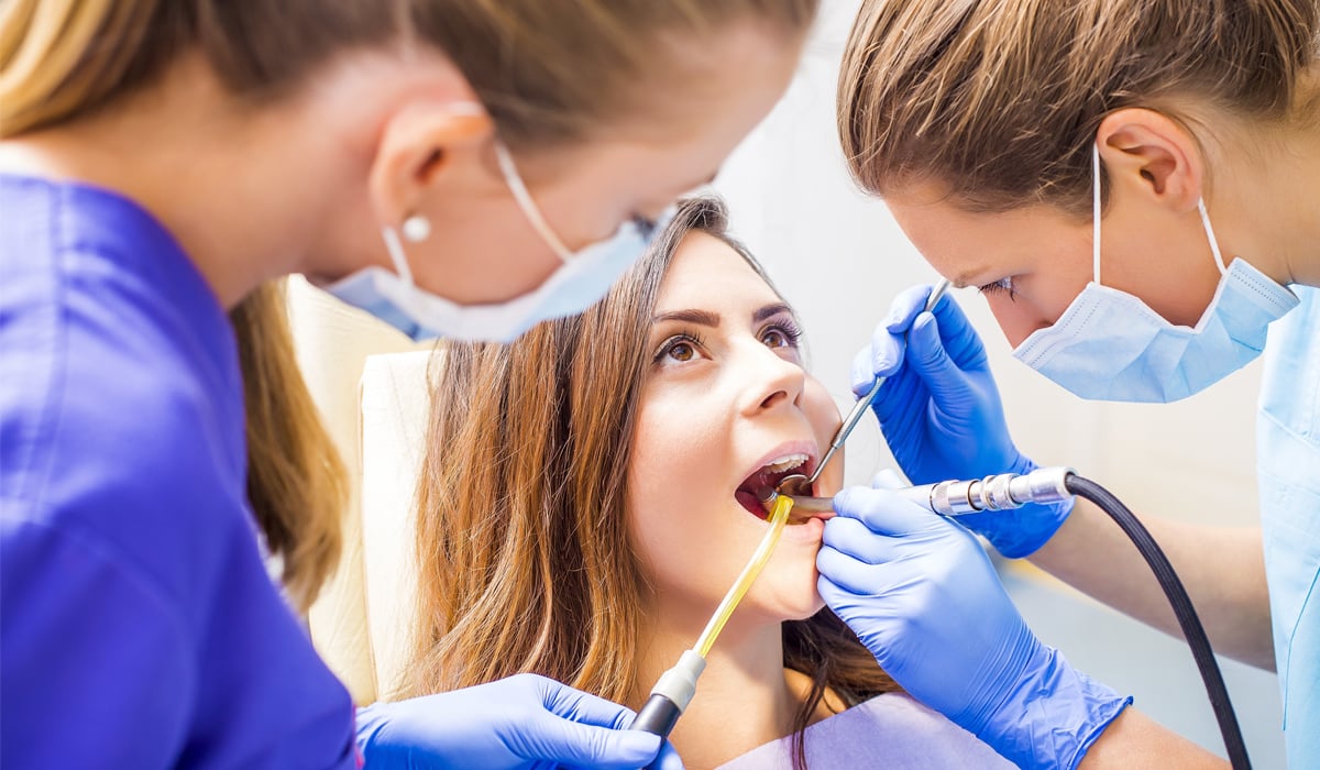 A dental team caring for a young patient.