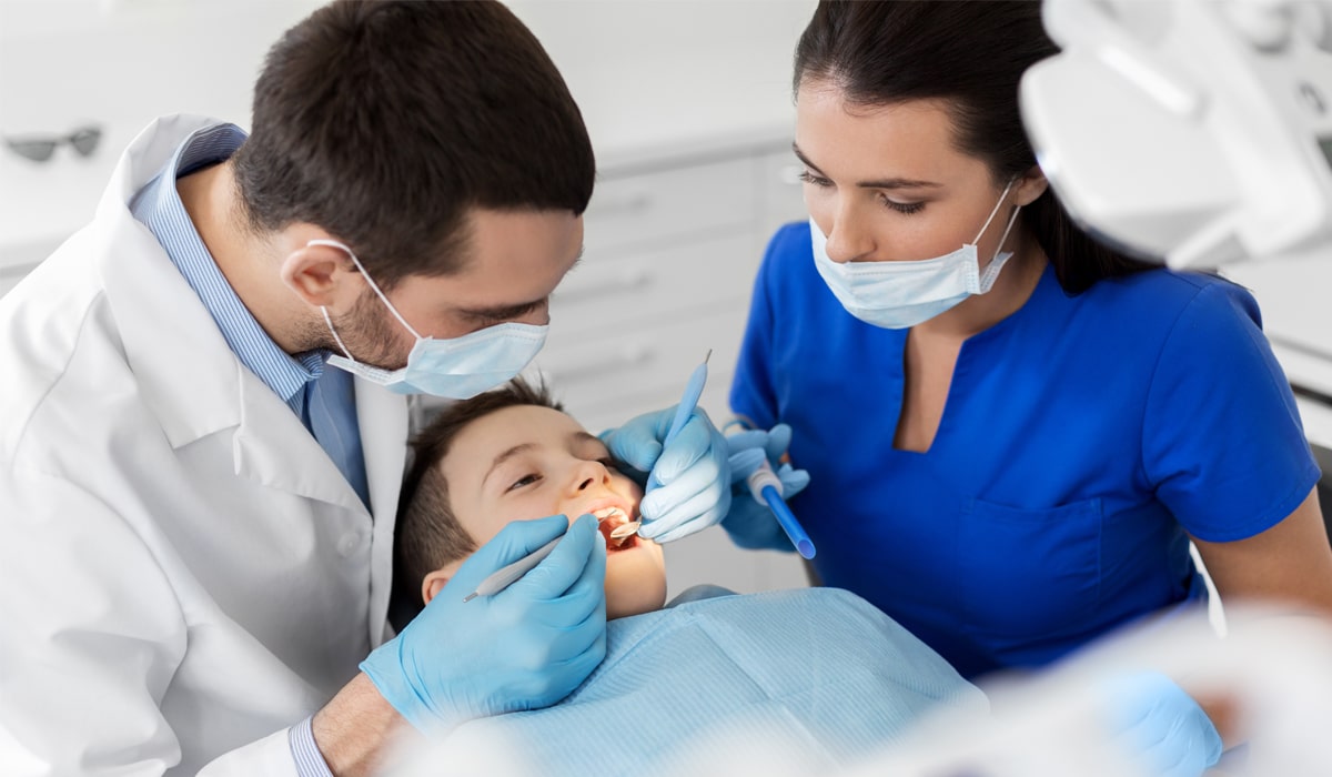 A dental team providing care for a child.