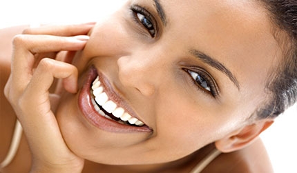 A smiling woman showing her natural teeth.